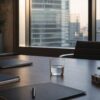Modern Tokyo financial office table with blank folders and a prototype component set against a blurred city business district.