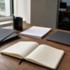 Blank folders, paper and a closed laptop on an investor research desk