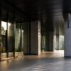 Morning light at a modern mixed-use building entrance in Tokyo