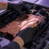 A technician aligns a copper liquid-cooling plate inside an unbranded AI server chassis.