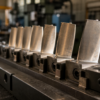 Unbranded gas-turbine blades arranged in a heavy-engineering machining fixture