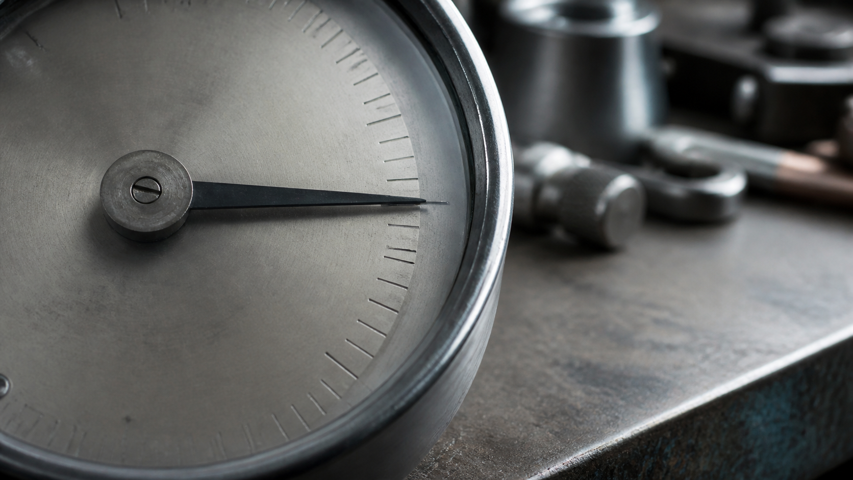 An unnumbered mechanical gauge pointer rests just beyond an engraved notch.