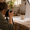 An independent ceramic maker photographs an unbranded mug in a small workshop.