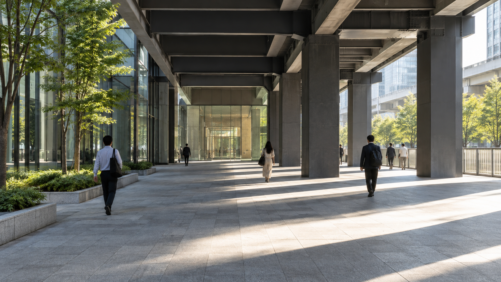 Pedestrians pass through a sunlit public concourse beneath a modern rail viaduct.