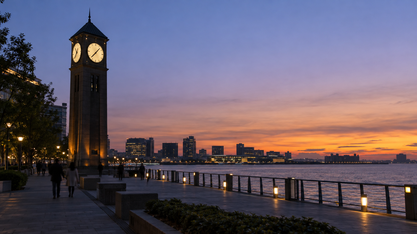 An unbranded clock tower stands beside a waterfront promenade at blue hour.