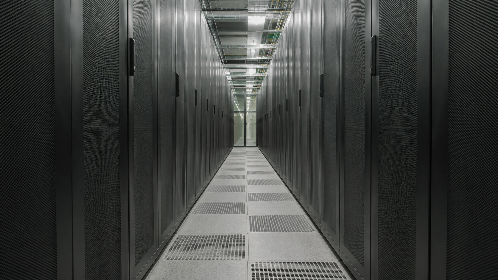 Unbranded data-center cold aisle with matte server cabinets and floor airflow grilles