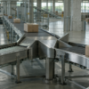A three-way stainless-steel conveyor diverter moves plain parcels through an unbranded sorting hall.