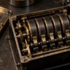 A close view of an unbranded brass-and-black mechanical register mechanism inside a test-instrument enclosure.